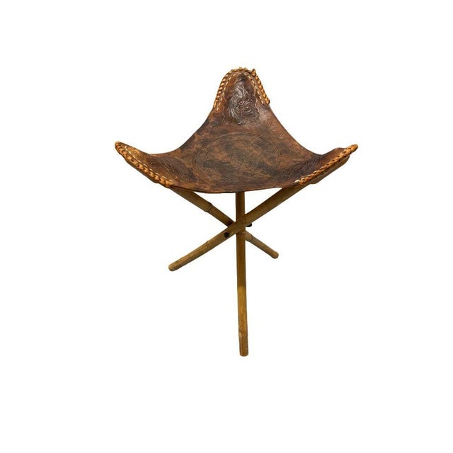 Add a touch of rustic charm and practicality to your space with this Vintage 1960s Mexican Leather Tripod Folding Stool....