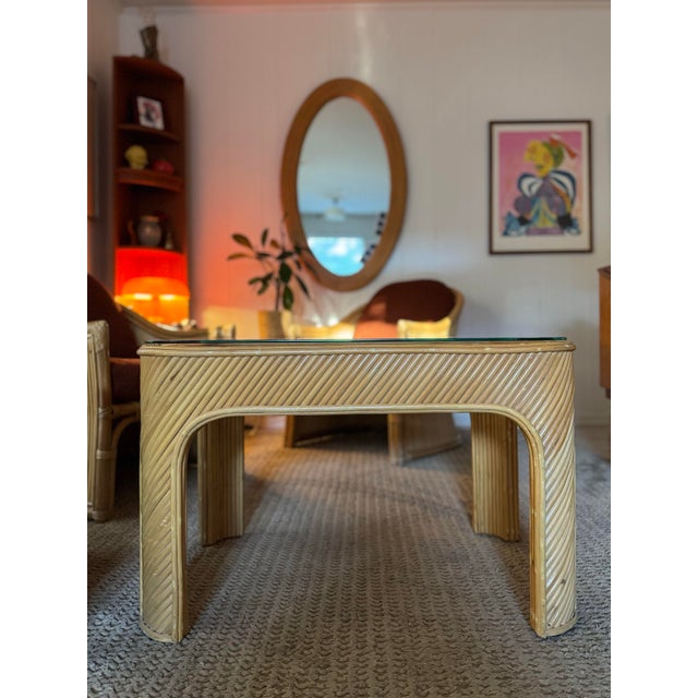 A sculptural set of three mid century modern rattan club chairs with a side table in the style of Gabriella Crespi, circa...