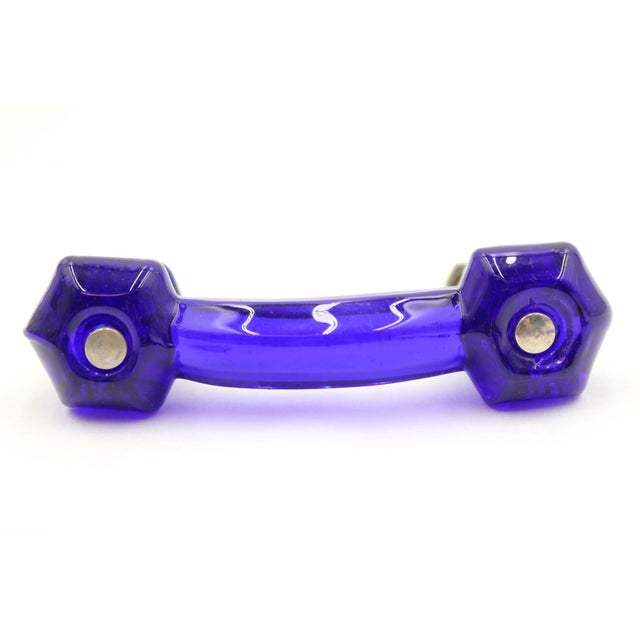 Vintage drawer pull made of blue glass with hexagon shaped ends. The original mounting nuts are included. Good condition...