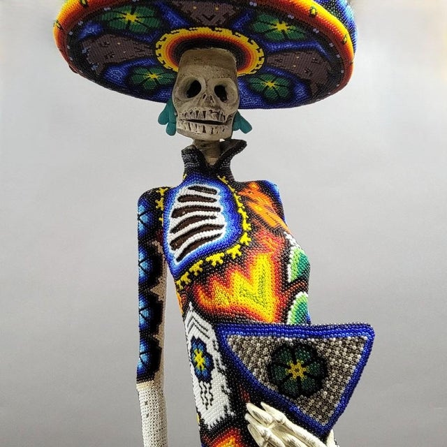 A monumental Huichol (Wixárika) beaded sculpture of La Catrina, executed at an impressive 36-inch scale. The figure is...