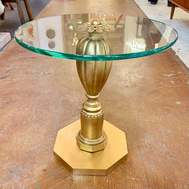 Graceful and glamorous, this vintage pedestal accent table brings together classical form and Hollywood Regency flair. The...