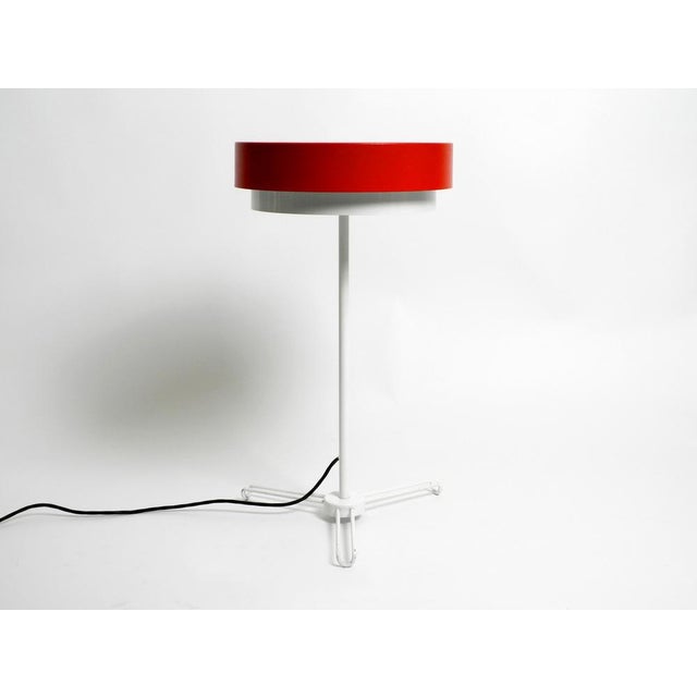 Very rare mid-century metal tripod patio floor lamp made of metal. Beautiful minimalist German design. The red and white...