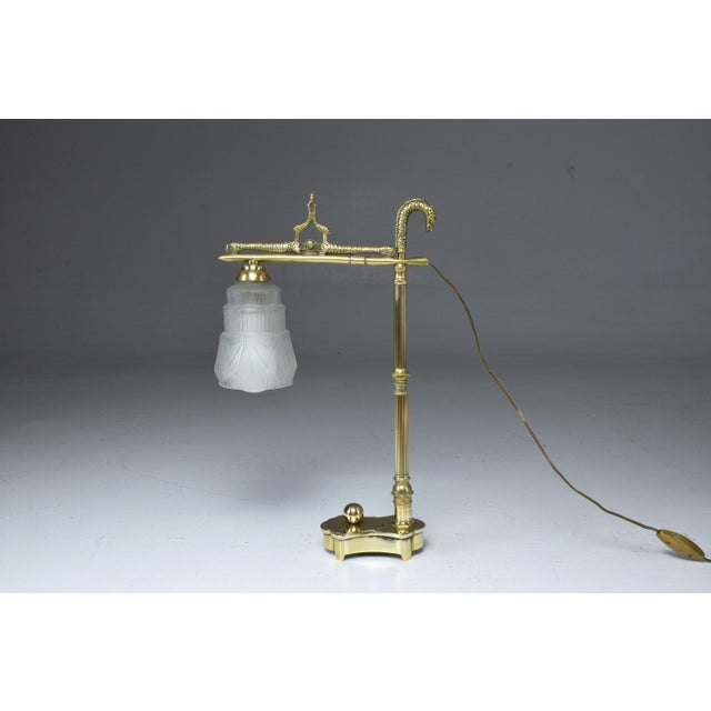 An original Vintage 20th century French Art Deco table accent lamp composed of a solid polished brass structure with...
