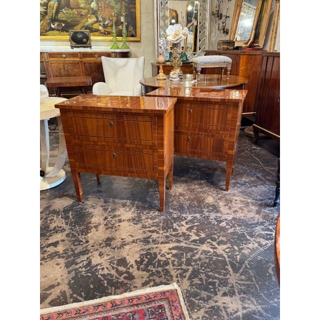 The product is a pair of Italian polished inlaid walnut Neo-Classical side tables. With intricate detailing and...