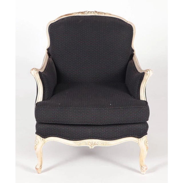 A painted and upholstered French Bergère chair having flared arms circa 1930. Ht: 36.5" Wd: 31.25" Dpth: 35.75" Seat...