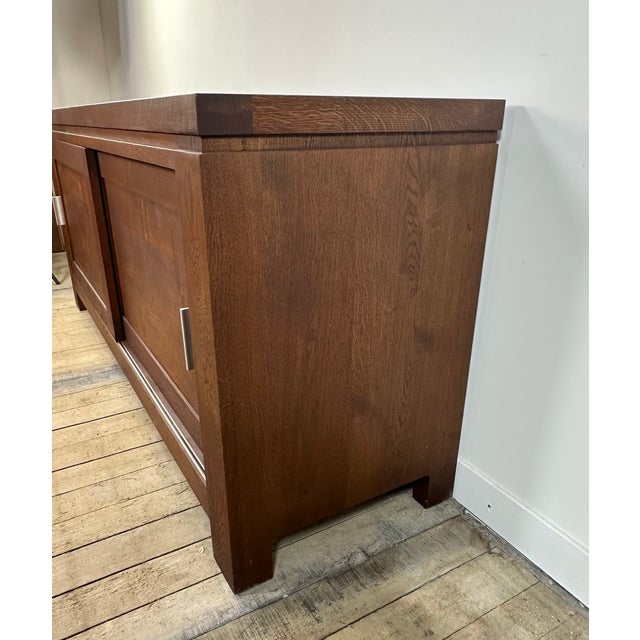 Brutalist style sideboard/buffet in solid oak, 1990s. Two sliding doors (on rails), very functional. Matte chrome handles....