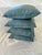A set of four custom-made blue-green silk-cotton pillows with contrasting aquamarine cord trim. Each pillow measures 18”...