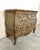This charming antique Louis XV-style commode exudes timeless French provincial elegance with its classic bombé silhouette,...