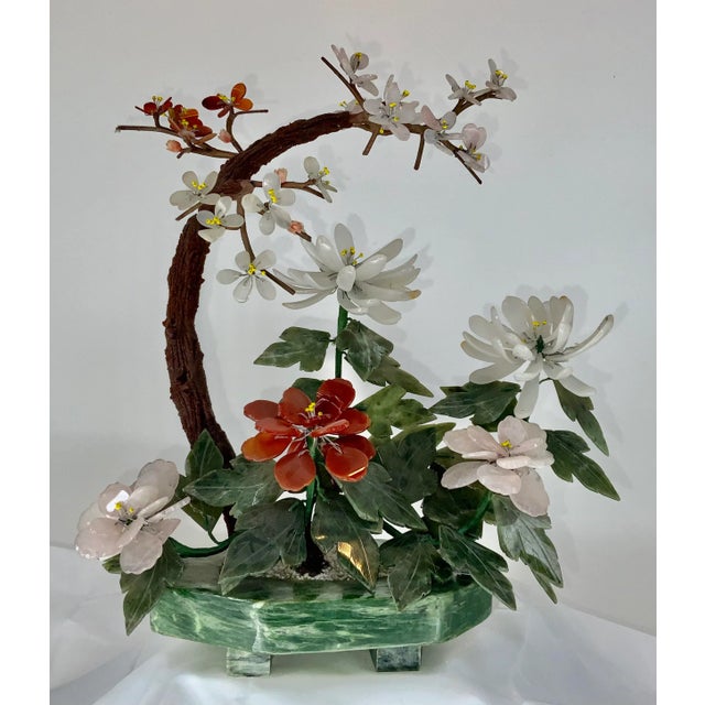 Beautiful vintage hand carved cherry blossom and peony in one green stone planter .