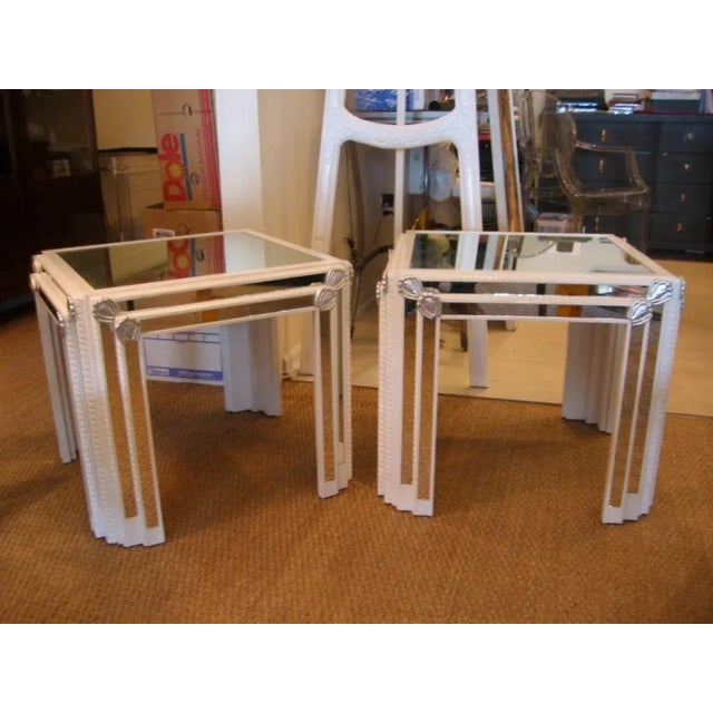 This pair of vintage side or end tables is in high gloss white lacquer with braiding detail surrounding all four sides....