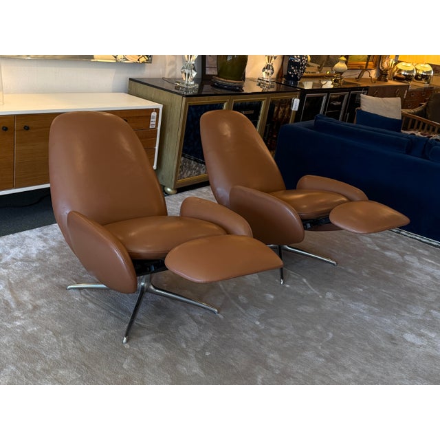 Design Plus Gallery presents a Pair of Sienna Leather Vala Swivel Recliners by Hlynur Atlason for Design Within Reach. The...