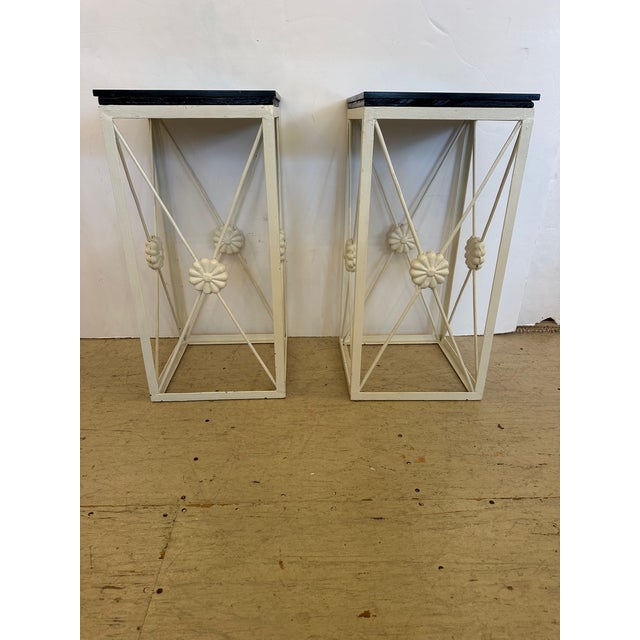 Pair of iron white painted metal open work side tables with stunning black granite tops.