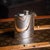 Vintage 20th century english solid silver hip flask of curved form. The body has a smooth finish throughout and features a...