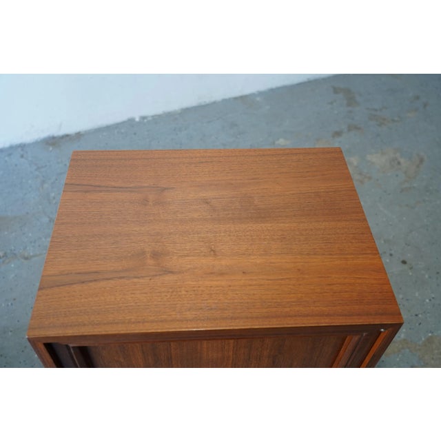 This Extremely Stylish pair of walnut nightstands, designed in the mid-20th century with American craftsmanship that will...