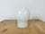 Vintage industrial ceiling or wall light made in former Czechoslivakia during the 1970s. It features a white porcelain...