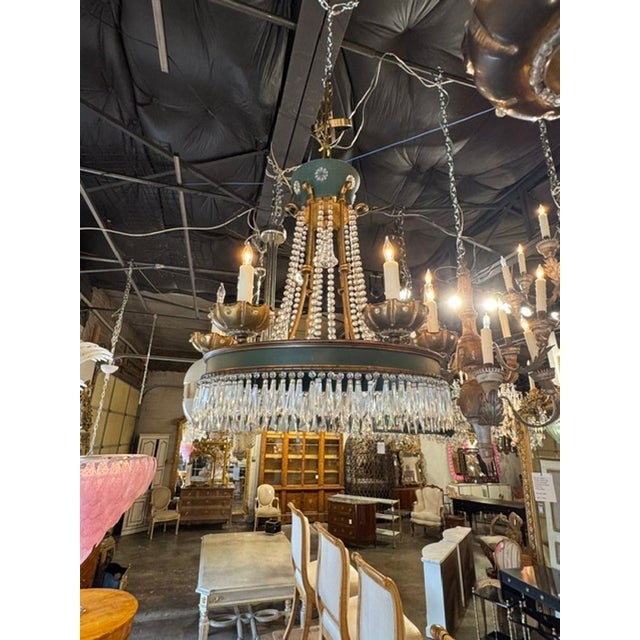 The Vintage French Maison Jansen manner Tole and Crystal Chandeliers are exquisite pieces of lighting fixtures that exude...