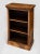 William IV pollard oak open bookcase with carved egg and dart decoration under the top with two adjustable shelves. It has...