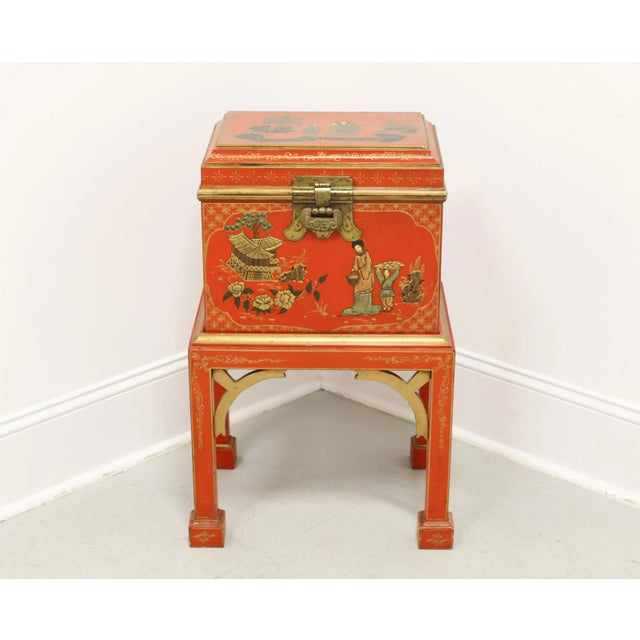 An Asian style decorative box sitting on a stand, unbranded. Hardwood painted an orange/red color with gold accents, hand...