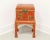 An Asian style decorative box sitting on a stand, unbranded. Hardwood painted an orange/red color with gold accents, hand...