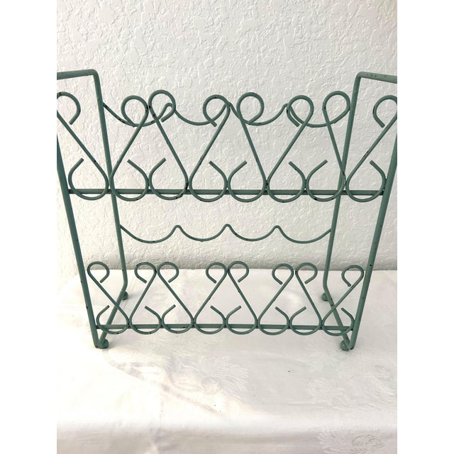 Pretty vintage ornate tabletop wine rack in Seafoam green. Holds four wine bottles.