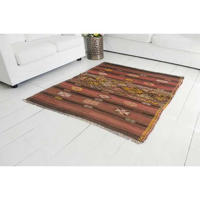 This is a vintage Turkish Oushak rug from the Mid 20th Century. The piece was hand-knotted.