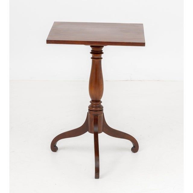 Federal Mahogany Lamp Table, the square top above turned wood stem terminating in three legs. 26.75" H x 18" W x 18.25" D....