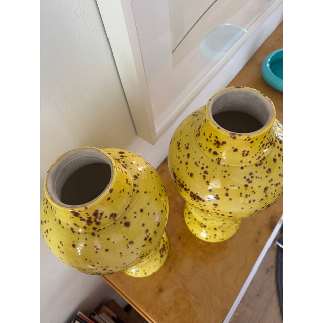 Gorgeous and dramatic pair of Mid-Century ceramic urns. bright, bold yellow in color with chocolate brown splatter...