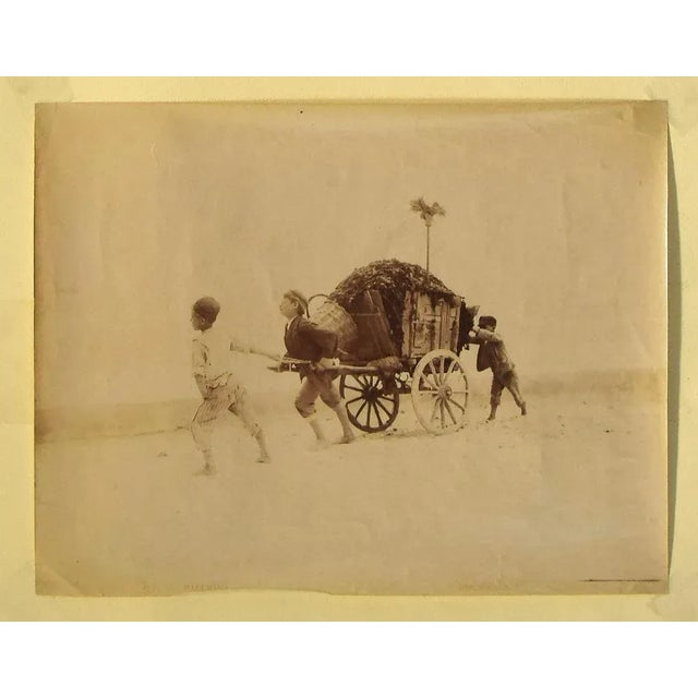 Boys Pulling a Wagon is an original Silver Salt Photographic Print realized by anonymous artist in late-19th century. Good...
