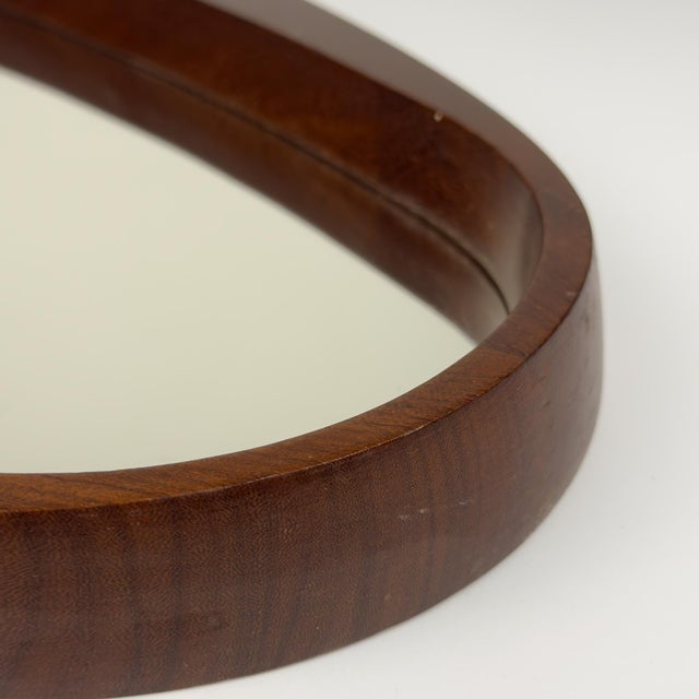 Mid-century wall mirror with Teak made in Italy in the 1960s. The vintage mirror is in very good vintage condition. The...