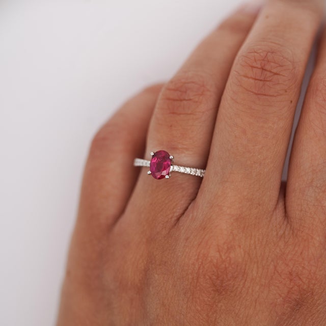18K white gold ring featuring a GIA certified 1.25 carat oval Burma ruby, heated with minor residue, accented by 0.13...