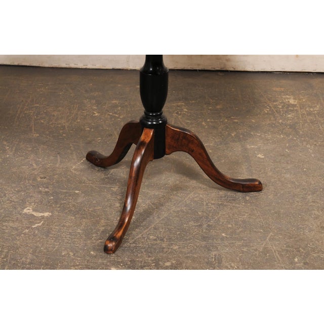 A Swedish burled alder wood pedestal table with tilt-top from the late 19th century. This antique table from Sweden...