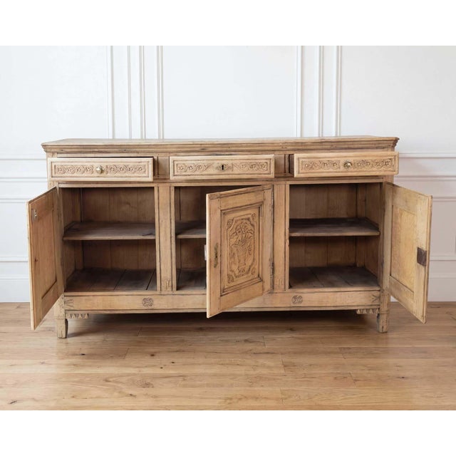 A striking 18th century Italian credenza crafted in richly grained walnut, showcasing the refined balance of architectural...
