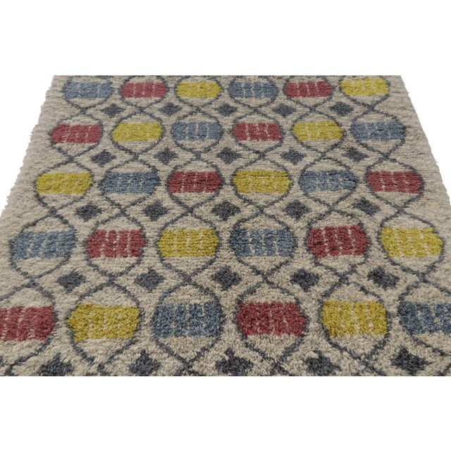 Hand-knotted in lush, high-pile wool in Sweden circa 1960-1970, this 5x7 vintage Swedish Rya rug is a bold new addition to...