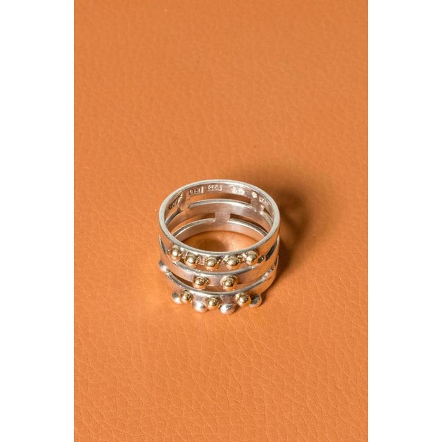 Silver ring by Cecilia Johansson, in a cool, clean design contrasted with a decor of silver and 9k gold balls. Large size,...