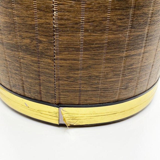 Elevate your bar game, with this mid-century brown and brass ice bucket. With a brass lid, and handle, this piece exudes...