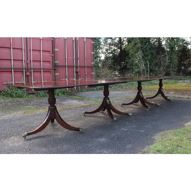 A large and impressive early 20th Century mahogany four pedestal dining table of exceptional quality, extending to just...