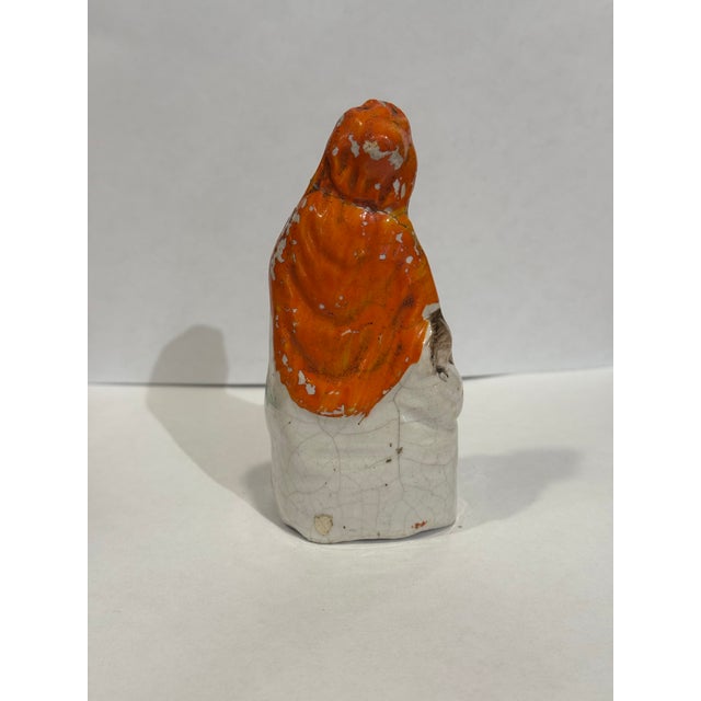 This is a 19th century Staffordshire Little Red Riding Hood figurine. It depicts the folklore character in an adorable way...