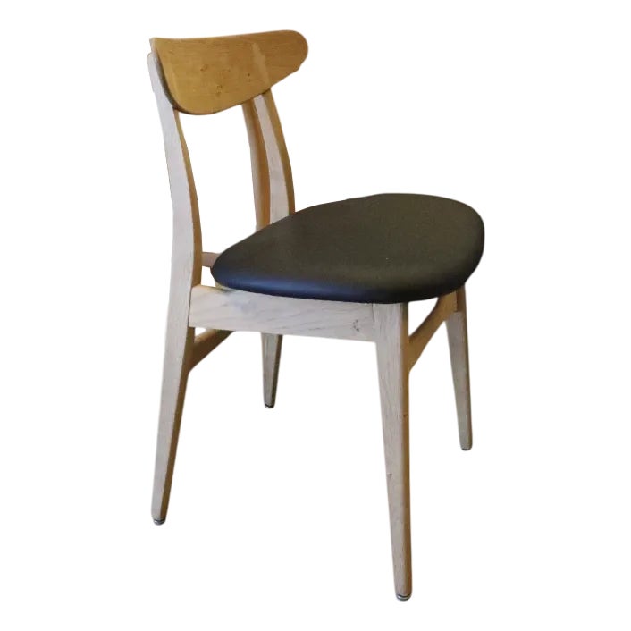 Chair with wooden frame and black leather seat