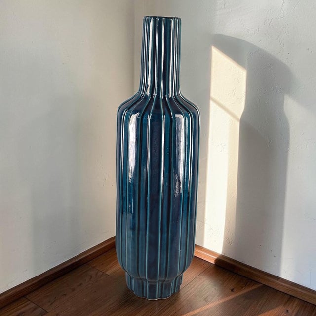 This Mid-Century-Modern Tall 24.5'' Ribbed Blue Glazed Pottery Floor Table Vase is a stunning piece of decorative pottery...