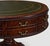 This is a lovely English drum table with Georgian styling. It has a green leather top. The frame is carved mahogany with...