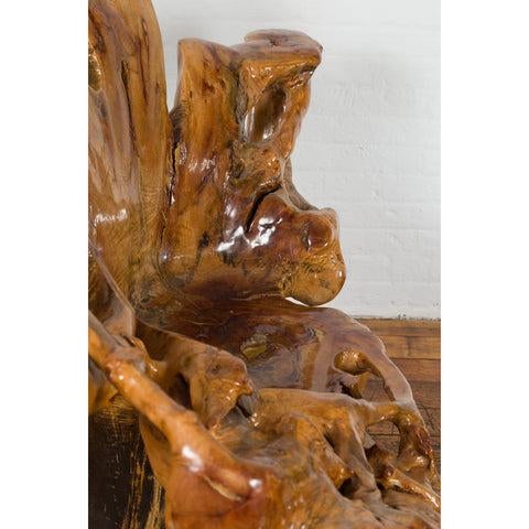A vintage Chinese hand-crafted camphor wood root chair from the 20th century, with light varnished patina and unusual...