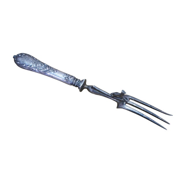 Antique French silver carving fork and a matching bone clamp (or manche à gigot) with ornate floral and scroll handles in...