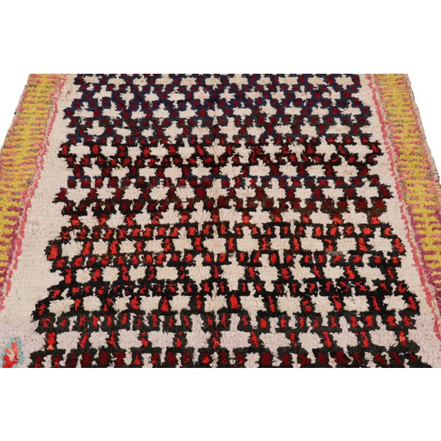 Hand-knotted in wool and originating from Morocco circa 1950-1960, this 4x6 vintage rug is a rare and among the most...