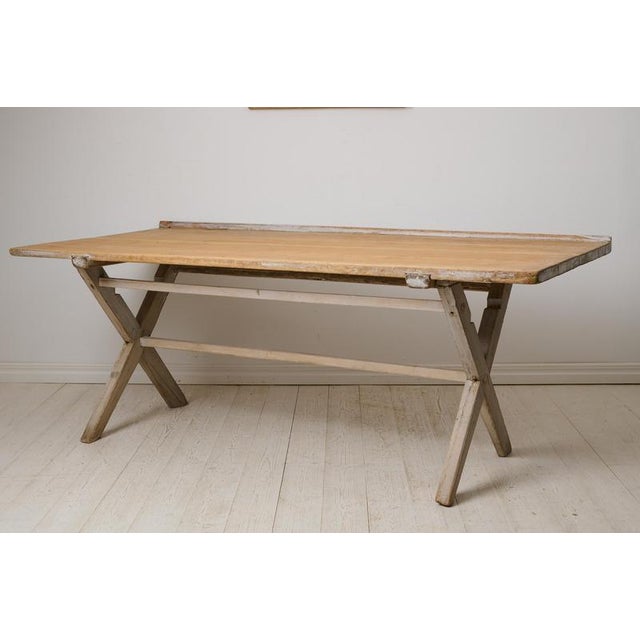 Country antique Swedish dining table or work table from the early 1800s. Made in northern Sweden around 1820 with a frame...