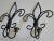 This pair of wrought iron fleur-de-lis candle sconces have a vintage patina with black/bronze finish. They would be great...