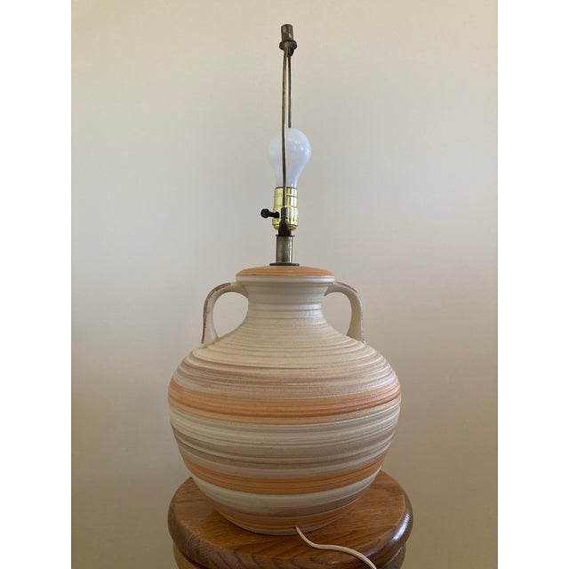 Great neutral southwestern coloring with cream, oranges, browns. Pottery texture is great design accent to any room! Lamp...