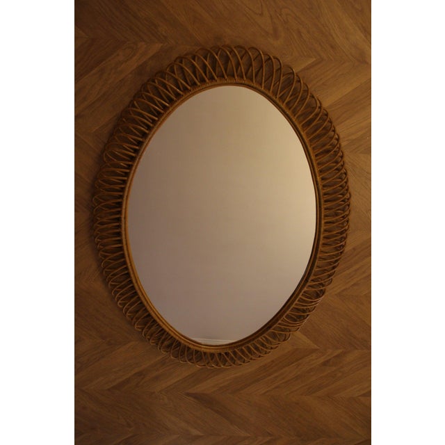 This highly decorative mirror was made in Italy in the 1960s. It is typical of the design of that period and is entirely...