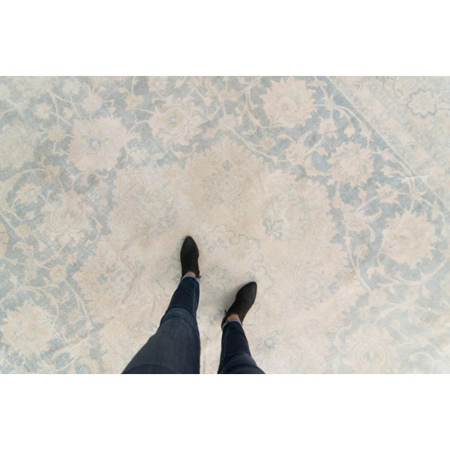 This beautiful hand-knotted distressed rug details a medallion with a botanical motif throughout the piece. This low-pile...