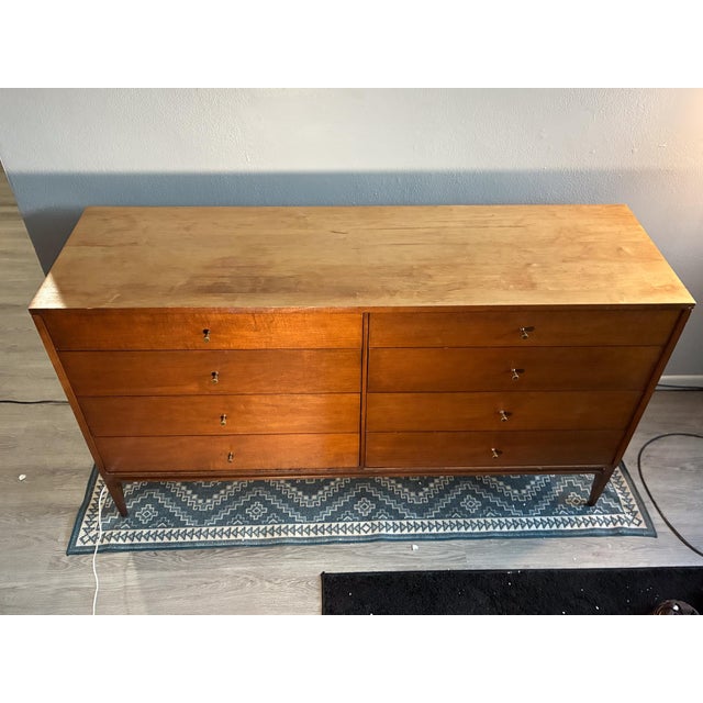 Mid-century modern 8-drawer dresser with a warm walnut finish and classic tapered legs. Carefully refinished to highlight...