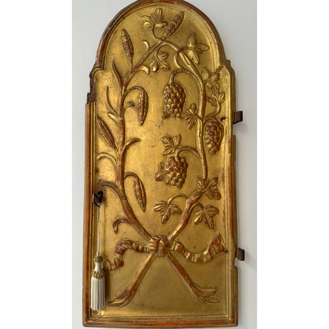 A late 18th-century gold-gilded wooden tabernacle door. This type of door closed tabernacles in which the ciborium...